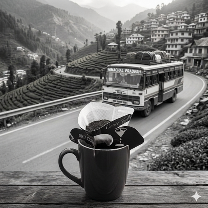 Vintage bus on a mountain road with a coffee filter and cup in the foreground.
